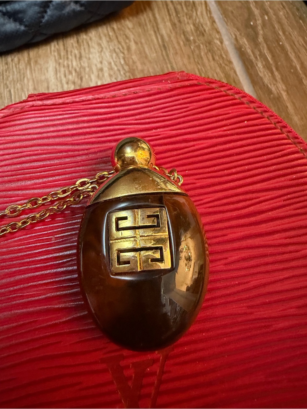 1977 vintage Givenchy Gold-tortoise necklace. Top opens. Perfume bottle.